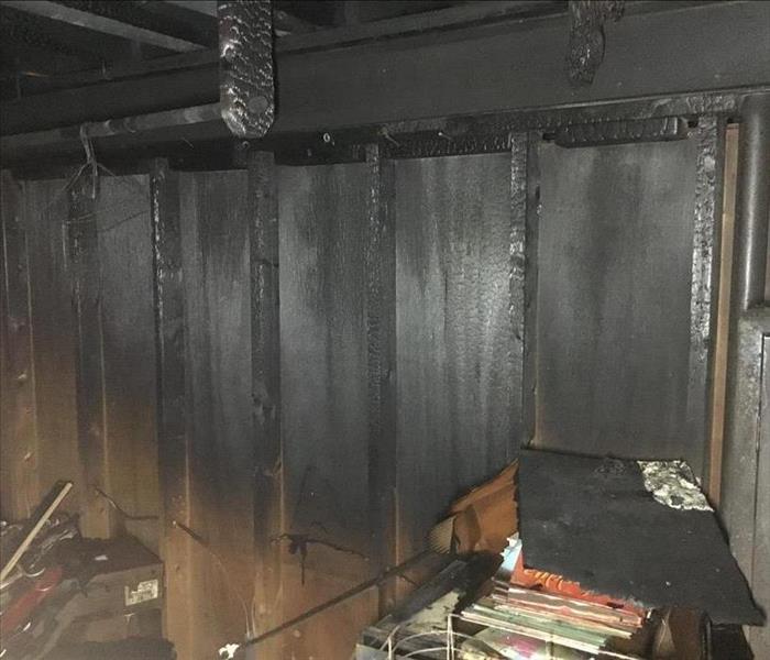 A basement and it's contents are damaged by smoke.