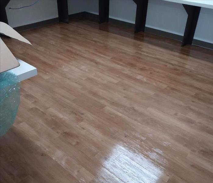 same hardwood floor after it has been scrubbed and buffed by SERVPRO