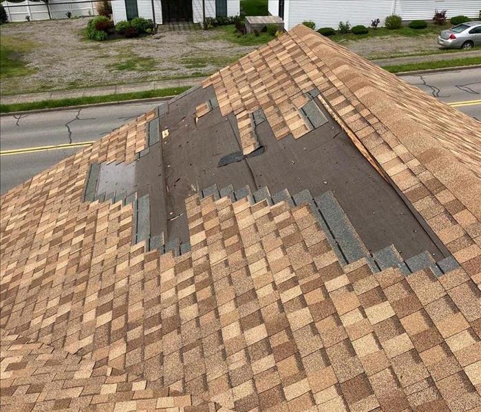 A roof is damaged by a storm.