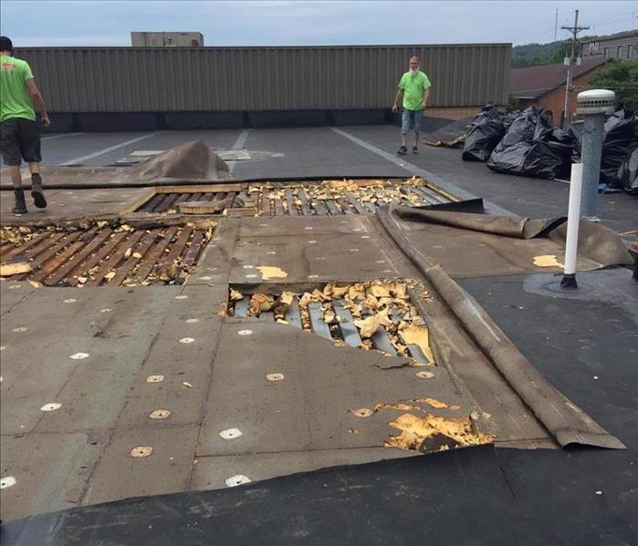 image of commercial roof top after a storm severely damaged the structure