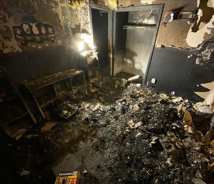 A bedroom and its walls has been damaged by fire.