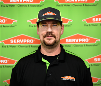 Image of male sitting in front of SERVPRO backdrop