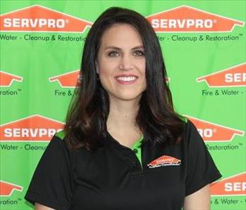image of female sitting in front of SERVPRO backdrop