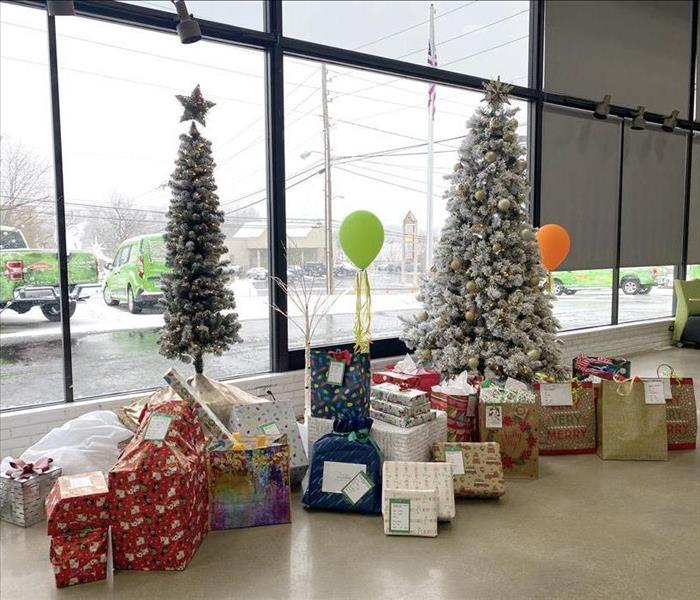image of gifts placed under a christmas tree ready to be donated