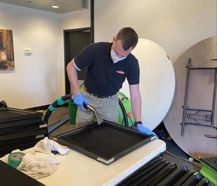 SERVPRO team member cleaning vents grilles.