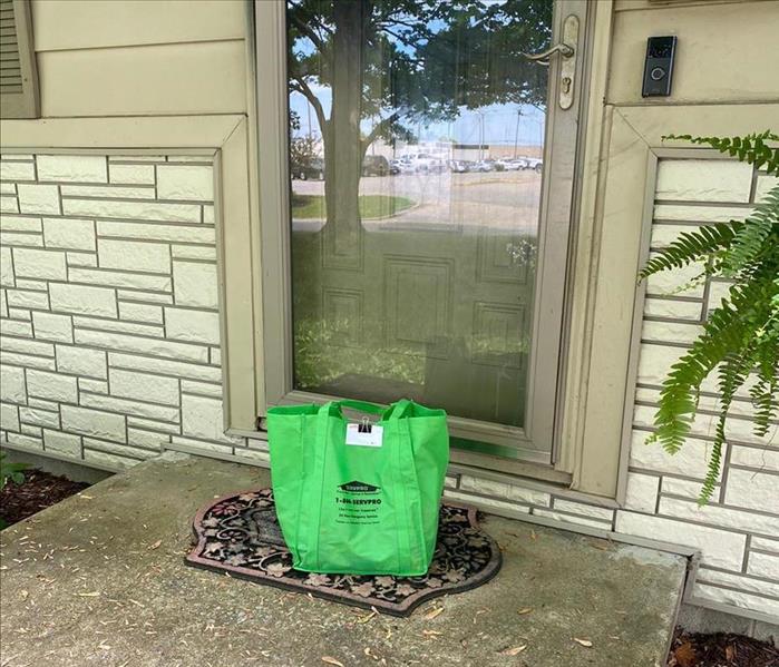image of a care bag placed on front porch of a home that experienced a fire