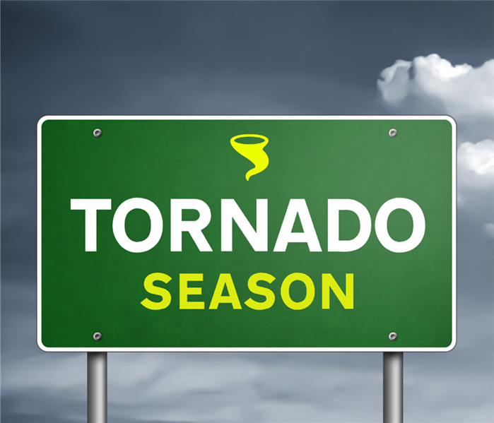 A green road sign says "Tornado Season"