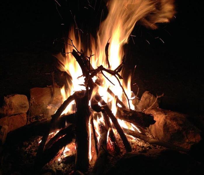 image of an outside bonfire with a moderately tall flame