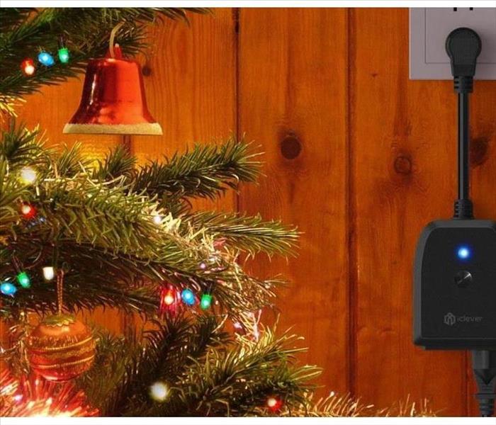 image of Christmas tree lights plugged into a wall outlet
